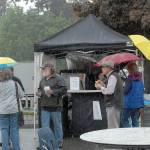 News Festival patrons stand in a pouring rain at a food booth during the 2019 Juan de Fuca Festival of the arts. Photo by Keith Thorpe/Olympic Peninsula News Group