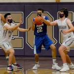 Sequims Jayden Possin, second from left, and Cole Smithson, right, poke the ball away from an East Jefferson player in the Wolves 64-40 win on May 10. Sequim Gazette photo by Michael Dashiell