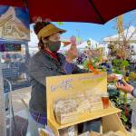 Shaelee Evans helps a customer at the Goodness Tea booth on May 1, the opening day of the markets 2021 season. Photo by Emma Jane Garcia/Sequim Farmers & Artisans Market