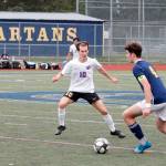 Sequims Eli Gish defends Bainbridges John Roman as he looks to pass upfield during the Olympic League boys soccer championship on April 28. Photo by Mark Krulish/Kitsap News Group