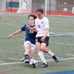 Sequims Ethan Anderson evades a tackle from Bainbridges Wyatt Friedman during the Olympic League boys soccer championship on April 28. Photo by Mark Krulish/Kitsap News Group