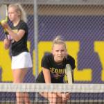 Kendall Hastings, foreground, awaits as sister McKenna prepares to serve in an Olympic League match in late March. The siblings went 14-0 on the 2021 season. Sequim Gazette photo by Michael Dashiell