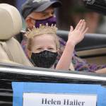 Eleanor Jones, who along with Emma Chapman represents Helen Haller Elementary School on the 2021 Sequim Irrigation Festival Junior Royalty court, waves to the crowd in downtown Sequim; her chauffeur is Jim Stoffer. Sequim Gazette photo by Michael Dashiell