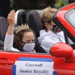 Evie Judd, who along with Aleah Daniels represents Greywolf Elementary School on the 2021 Sequim Irrigation Festival Junior Royalty court, waves to the crowd in downtown Sequim; her chauffeur is Monica Dixon. Sequim Gazette photo by Michael Dashiell