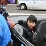 Mason Blake, winner of the 2021 Irrigation Festival Button Design contest, talks with festival emcee Stephen Rosales before the Grand Parade on May 8. Like his grandfather before him, Blake is a two-time button design contest winner. Sequim Gazette photo by Michael Dashiell