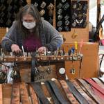 Jenny Preston of Chimacums Snow Creek Leather works on a belt at the Sequim Irrigation Festivals Innovative Arts and Crafts Fair in downtown Sequim Saturday, May 8. Ive been coming to this festival since as long as I can remember, possibly the 1970s, Preston said. With health restrictions in place the festival moved all but two events  the fair and the Grand Parade-turned-procession  to virtual presentations. See irrigationfestival.com. Sequim Gazette photo by Michael Dashiell