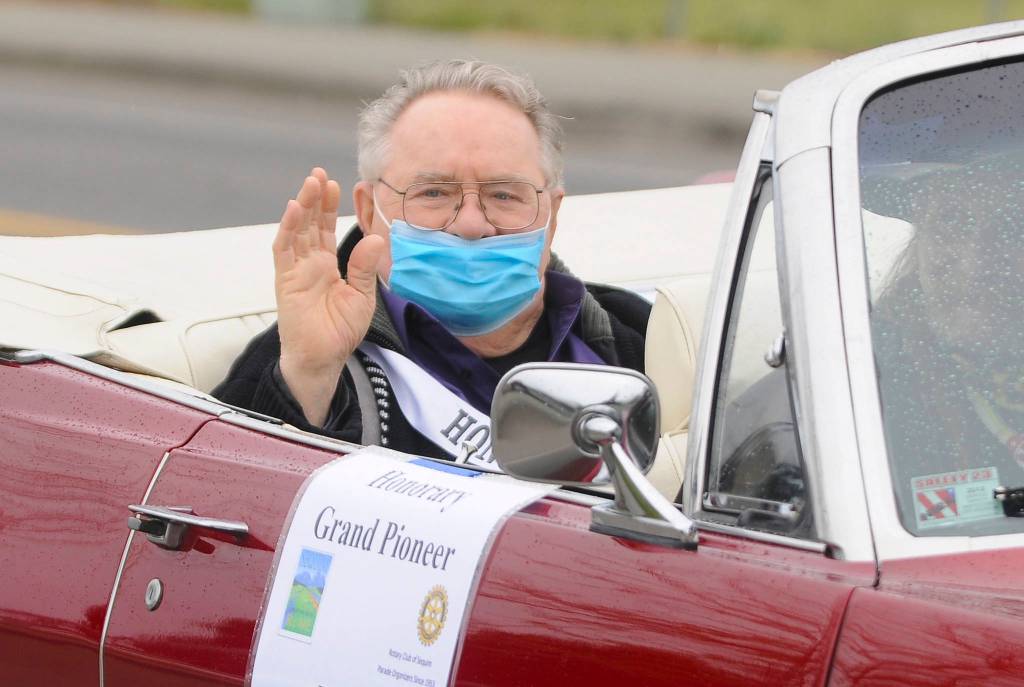 Honorary Pioneer Dick Parker waves to onlookers on North Sequim Avenue during the May 8 Grand Parade. Sequim gazette photo by Michael Dashiell