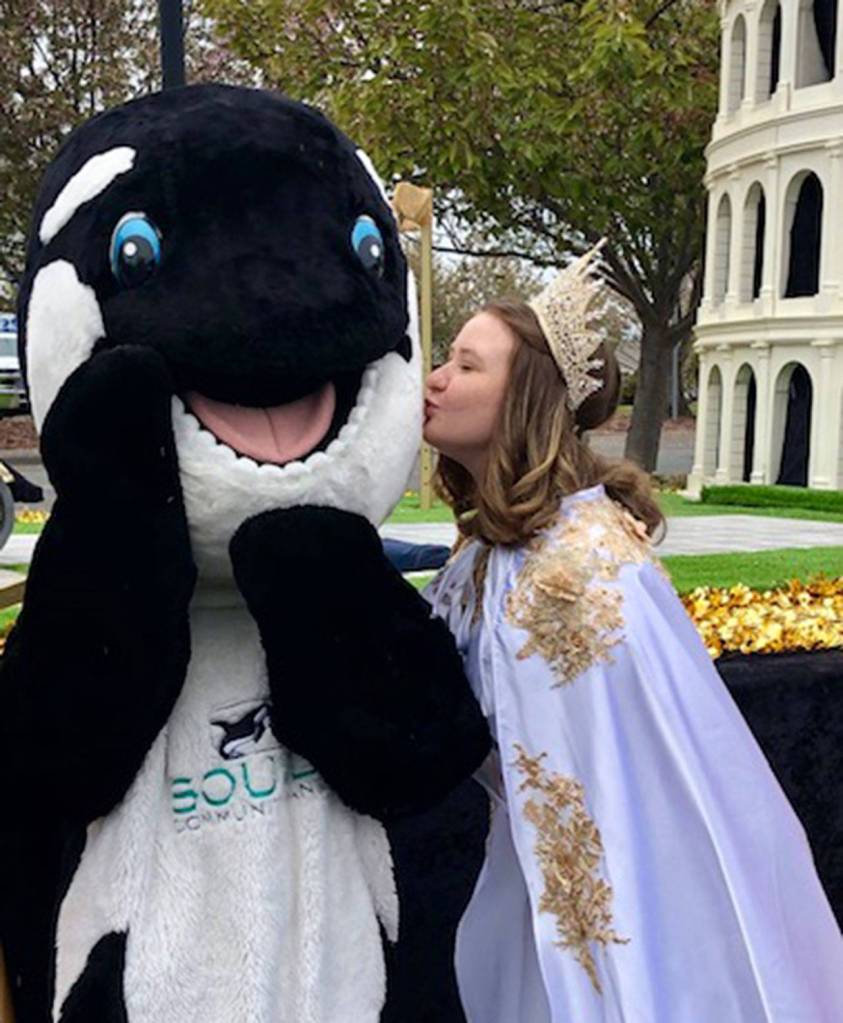 Sounder  the mascot of Grand Parade sponsor Sound Community Bank  gets a from Queen Hannah Hampton. Submitted photo
