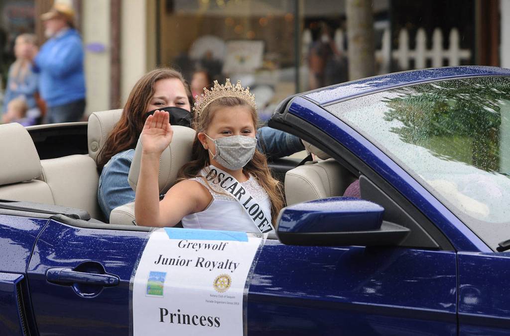 Aleah Daniels, who along with Evie Judd represents Greywolf Elementary School on the 2021 Sequim Irrigation Festival Junior Royalty court, waves to the crowd in downtown Sequim. Sequim Gazette photo by Michael Dashiell