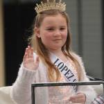 Emma Chapman, who along with Eleanor Jones represents Helen Haller Elementary School on the 2021 Sequim Irrigation Festival Junior Royalty court, waves to the crowd in downtown Sequim. Sequim Gazette photo by Michael Dashiell