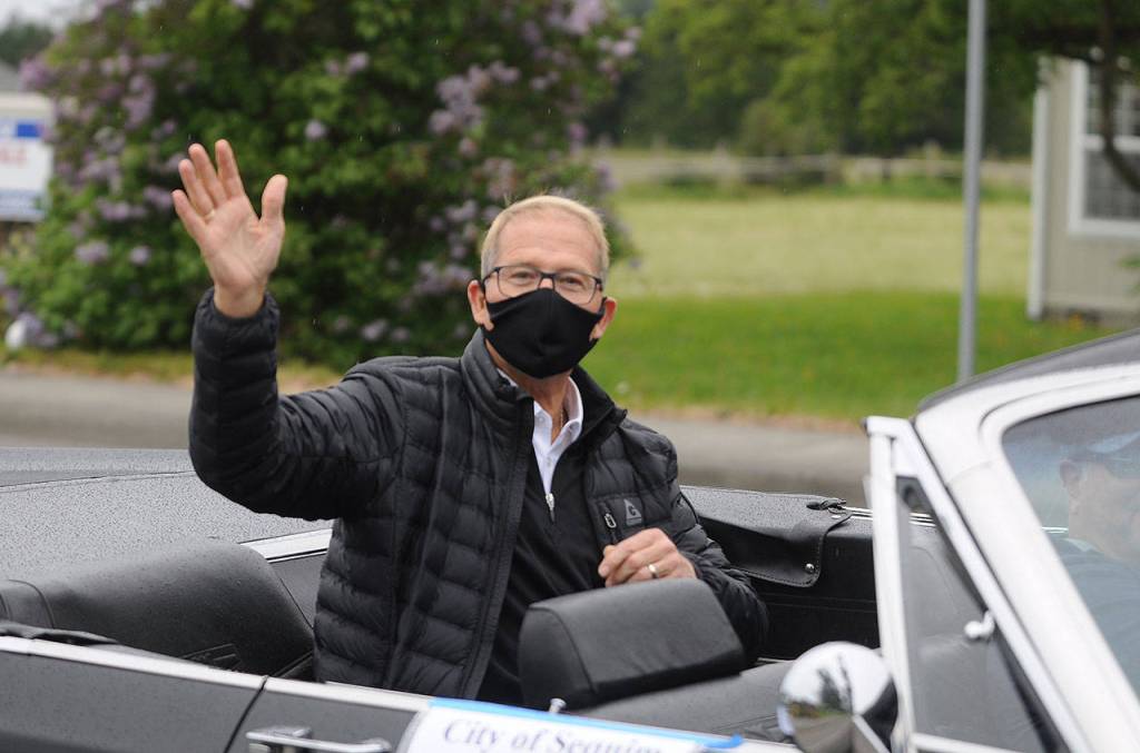 Sequim mayor William Armacost waves to the Grand Parade crowd on North Sequim Avenue. Sequim Gazette photo by Michael Dashiell