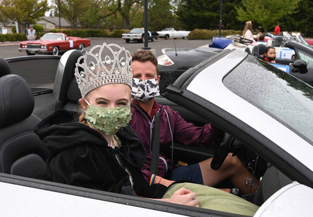 2020 Irrigation Festival queen Lindsey Coffman gets a ride in the 2021 Grand Parade with chauffeur Marcus Oden. Sequim Gazette photo by Michael Dashiell