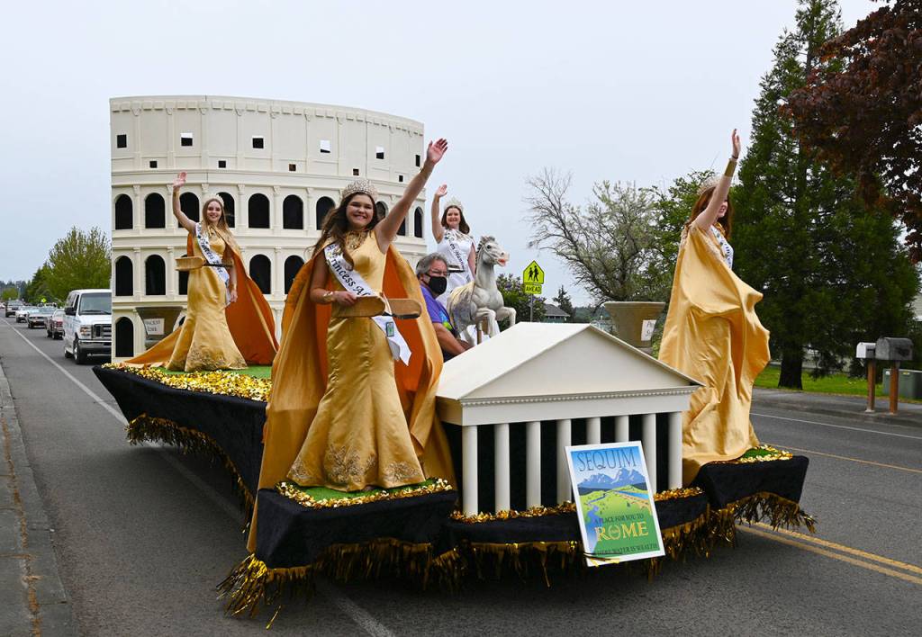Sequim Irrigation Festival royalty wave to the Grand Parade mini crowds on North Sequim Avenue. Sequim Gazette photo by Michael Dashiell