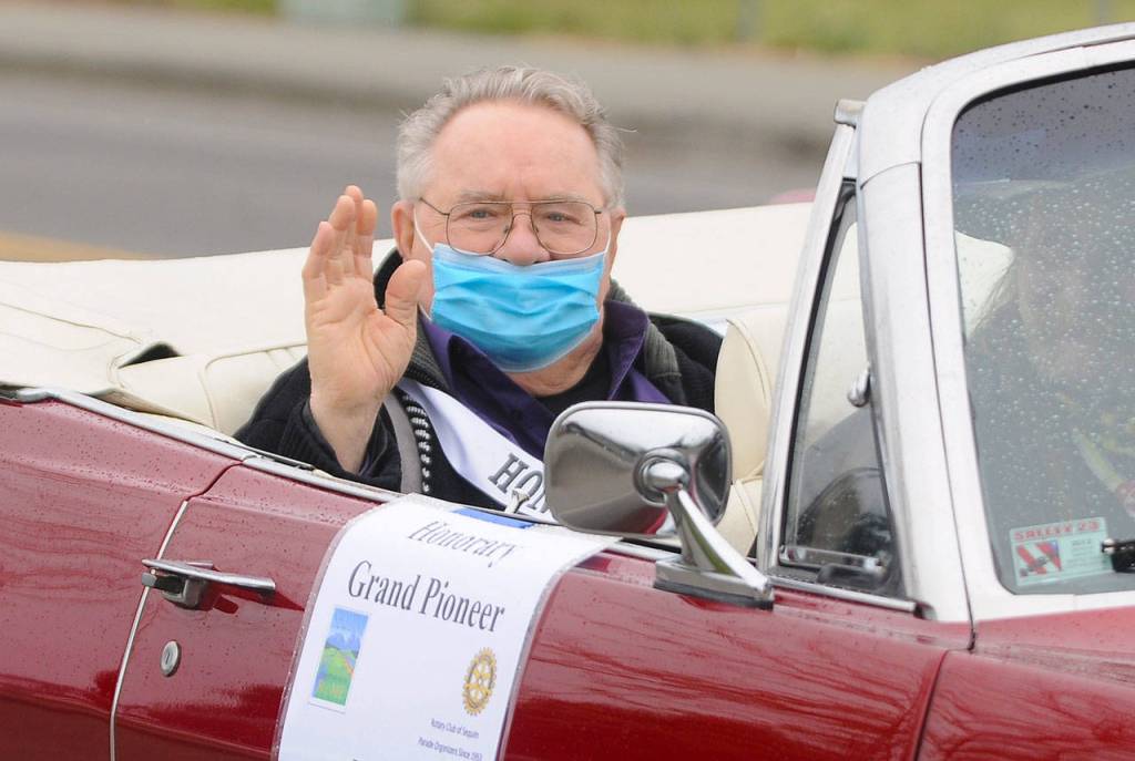 Honorary Pioneer Dick Parker waves to onlookers on North Sequim Avenue during the May 8 Grand Parade. Sequim Gazette photo by Michael Dashiell