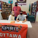 Walker Ward, pictured here with with his father Paul Ward and girlfriend Olivia Hare and father Paul Ward, announces last week his intent to play football at Ottawa University in Surprise, Ariz. Sequim High teammate Michael Young also signed an intent to plat at Ottawa this fall. Submitted photo
