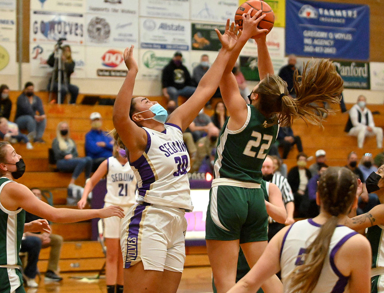 Sequims Jayla Julmist (30) vies for a rebound with Port Angeles Eve Burke in an Olympic League game in Sequim on May 12. Port Angeles topped the host Wolves, 67-58. Sequim Gazette photo by Michael Dashiell