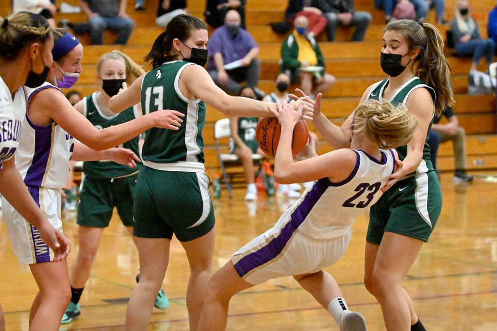 Sequims Melissa Porter (23) snags the ball from Port Angeles Bailee Larson (13) in the first half of the Roughriders 67-58 win at Sequim on May 12. Sequim Gazette photo by Michael Dashiell