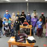 Sequim Sunrise Rotarians presented a donation to the Sequim Boys & Girls Club last week to help pay for laptops, a storage cart and desks (that Rotarians built) to help students with remote learning. Sequim Gazette photo by Matthew Nash