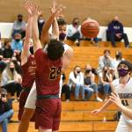 Sequims Hayden Eaton slips a pass through the Kingston defense in the second half of the Wolves 64-51 loss to the Buccaneers on May 18. Sequim Gazette photos by Michael Dashiell