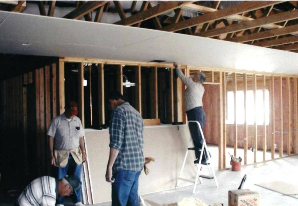 Volunteers work in 2002 on new office and bathroom space as part of an addition.