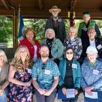 Representatives from the Jamestown SKlallam Tribe, Dungeness River Audubon Center and Olympic Peninsula Audubon Society (OPAS) come together to accept an award from the National Society of the Daughters of the American Revolution Saturday at the river centers amphitheater. Pictured are (back row, from left) former river center director Bob Boekelheide; OPAS member/president Ken Wiersma; (middle row, from left) Theresa R. Lehman, Jamestown SKlallam Tribe council treasurer; Kendra Donaldson, capital campaign member and Olympic Peninsula Audubon Society member; Annette Hanson, river center founder and capital campaign chair; W. Ron Allen, Jamestown SKlallam Tribe council chair and CEO; and (front row, from left) Annette Nesse, Jamestown SKlallam Tribe program transportation manager; Vanessa Fuller, Dungeness Audubon River Center administrative services and development manager; river center director Powell Jones; Lyn Muench, river center board member, and Clare Hatler, capital campaign committee member. Sequim Gazette photo by Michael Dashiell