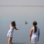 Chenelle Stark, 8, throws a dead Dungeness crab she found in Cline Spit as her sister Kieryn Stark, 10, watches. Sequim Gazette photo by Matthew Nash