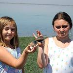 Sisters Chenelle, 8, and Kieryn, 10, Stark hold clams that Chenelle found exploring Cline Spit while cooling off on June 26. They were visiting grandma Wanda Meema Stark for the day. Sequim Gazette photo by Matthew Nash