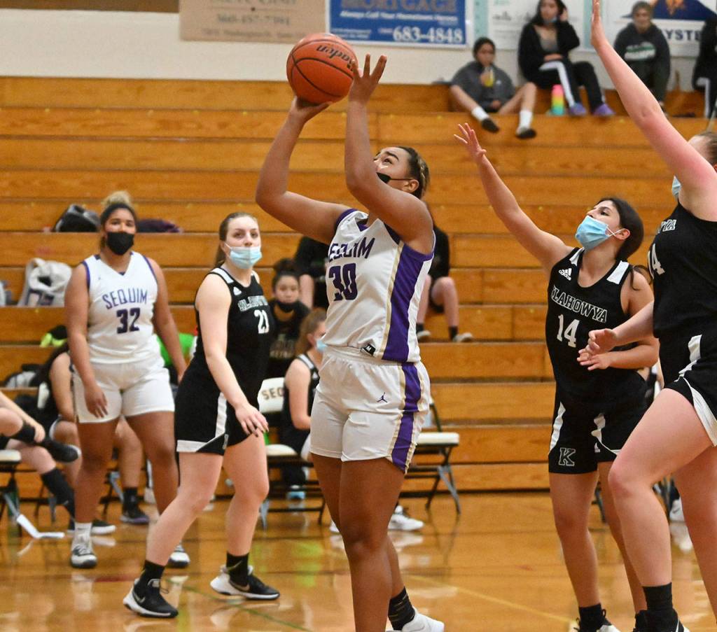 Sequim senior Jayla Julmist, center, goes to the basket for two of her game-high 16 points in the Wolves 68-8 win over visiting Klahowya on May 25. Sequim Gazette photo by Michael Dashiell