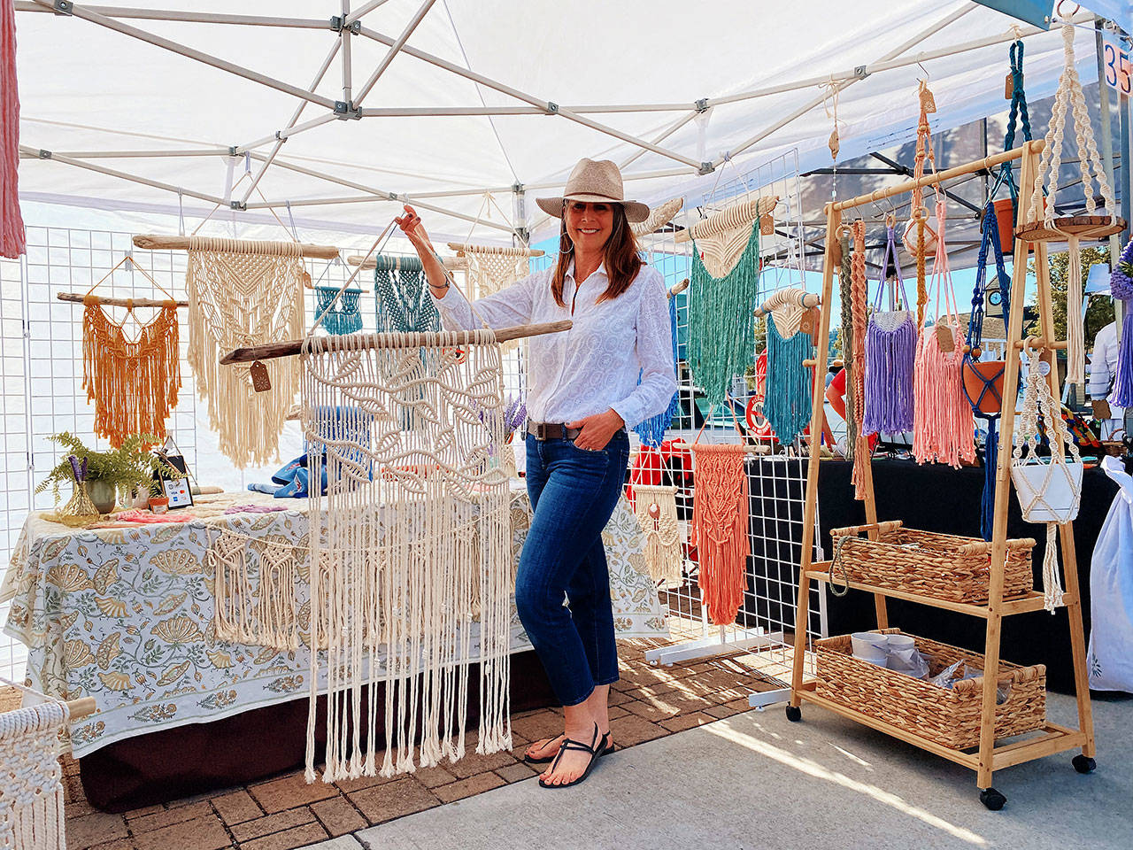 Shelly Weber of PNW GIRL brings her wall hangings, hand-woven plant holders and other wall art to the Sequim Farmers & Artisans Market each Saturday. Photo by Emma Jane EJ Garcia