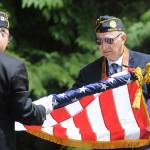 Philip Capogna, right, and Paul Rogers gather the star sand stripes after a Memorial Day ceremony at Blue Mountain Cemetery on May 31. The event was the fourth of four such events hosted by American Legion Posts 62 and 29 that included Sequim View Cemetery, Jamestown Cemetery and Dungeness Cemetery. Sequim Gazette photo by Michael Dashiell