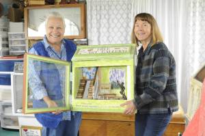 Eva Kozun and Gayle Selby hope the community keeps creating art for Free Little Art Galleries coming to the Sequim area this summer. Selby sent an article to Kozun in January that led the mixed-media artist to create four galleries with one posted so far at Dungeness Dandelion Botanical Company, 4681 Sequim Dungeness Way. Sequim Gazette photo by Matthew Nash