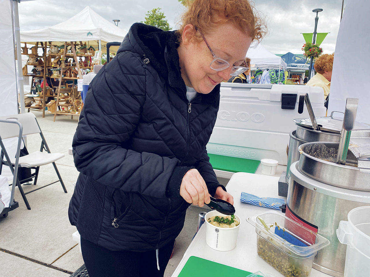 Charity Brock, head chef and owner of Reds at the Market, offers her signature smoked salmon chowder at the Sequim Farmers & Artisans Market this summer. Photo by Emma Jane EJ Garcia