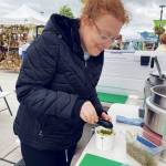 Charity Brock, head chef and owner of Reds at the Market, offers her signature smoked salmon chowder at the Sequim Farmers & Artisans Market this summer. Photo by Emma Jane EJ Garcia