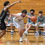 Left: Sequims Cole Smithson, right, looks to drive past Central Kitsaps Maurice Green in the Wolves 72-49 loss to Central Kitsap on June 2. Above: Sequim guard Erik Christiansen drives past Maurice Green to the basket for a score. Sequim Gazette photos by Michael Dashiell