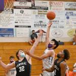 Sequims Isaiah Moore puts up a shot as Central Kitsaps Ian Massey and Maurice Green defend in the Wolves 72-49 loss to Central Kitsap on June 2. Sequim Gazette photo by Michael Dashiell