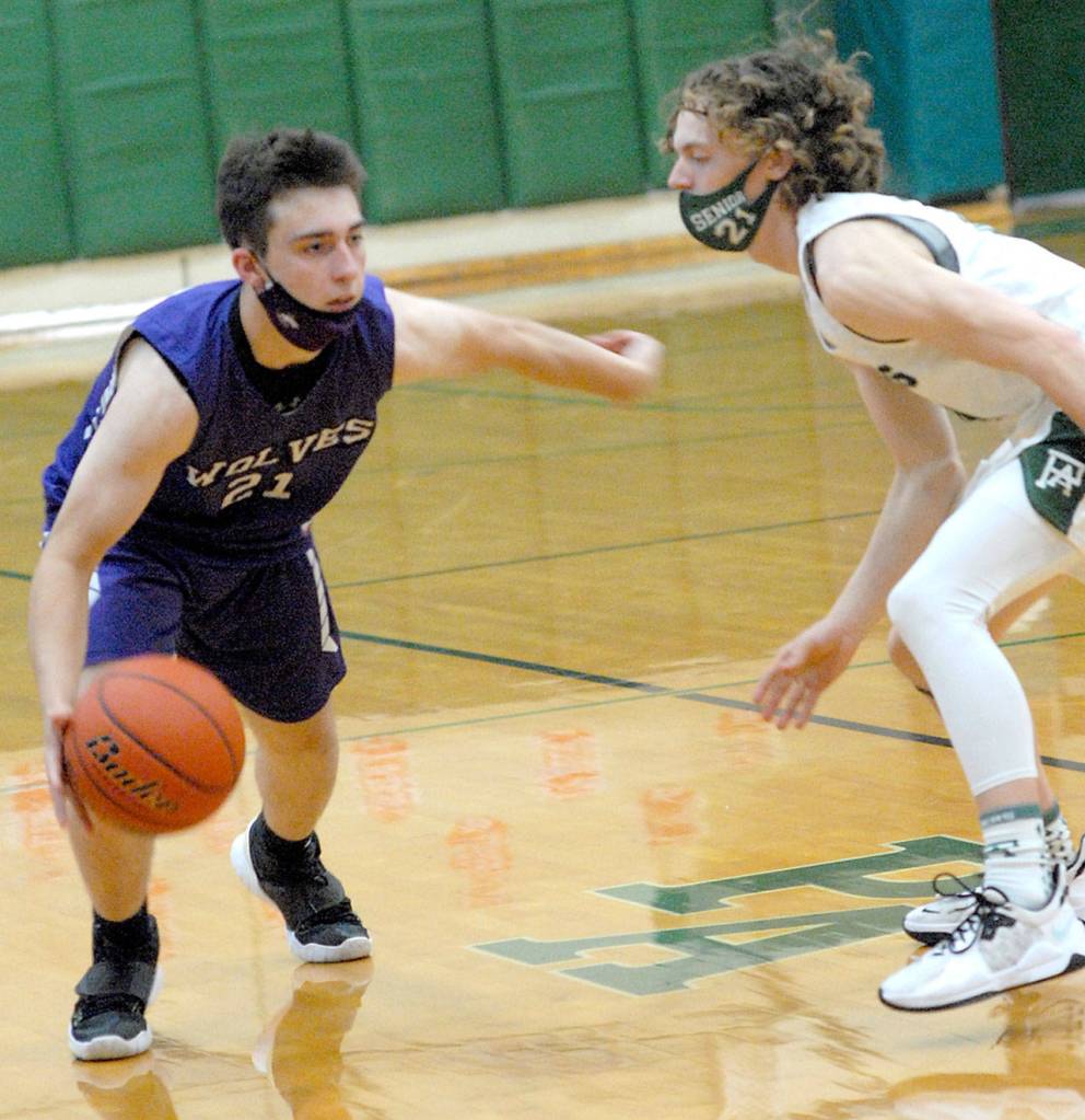 Keith Thorpe/Peninsula Daily News
Sequim's Jayden Possin, left, looks for a way around Port Angeles' Dru Clark on Saturday night in Port Angeles.