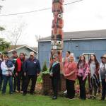 The family of Jamestown SKlallam Tribal elder Harris Brick Johnson celebrate a rededication of his totem at Pioneer Memorial Park on June 5. Family members include, from left, Sandy Johnson, Rosalynn McKenna, Shawna Priest holding Jameson Carver, Josh Carver, Terry Johnson, Steve Johnson, Rosie Zwanziger, Jessica Johnson, Vickie Carroll, Sonni and Jolie Creech, Susan Johnson and Verna Johnson. Photo courtesy of Betty Oppenheimer/Jamestown SKlallam Tribe