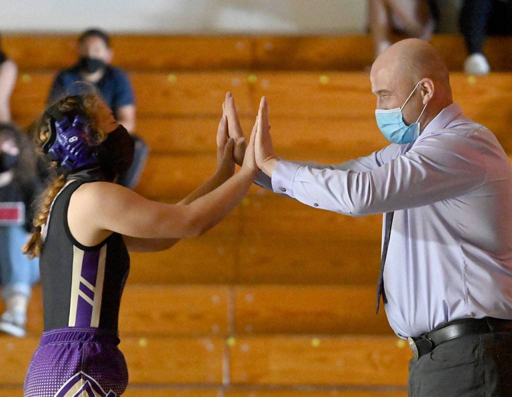Sequims Jordan Hegtvedt gets congratulated by SHS coach Chad Cate after turning an 11-2 deficit into a pin of Bainbridges Victoria Hutton on June 5. Sequim gazette photo by Michael Dashiell