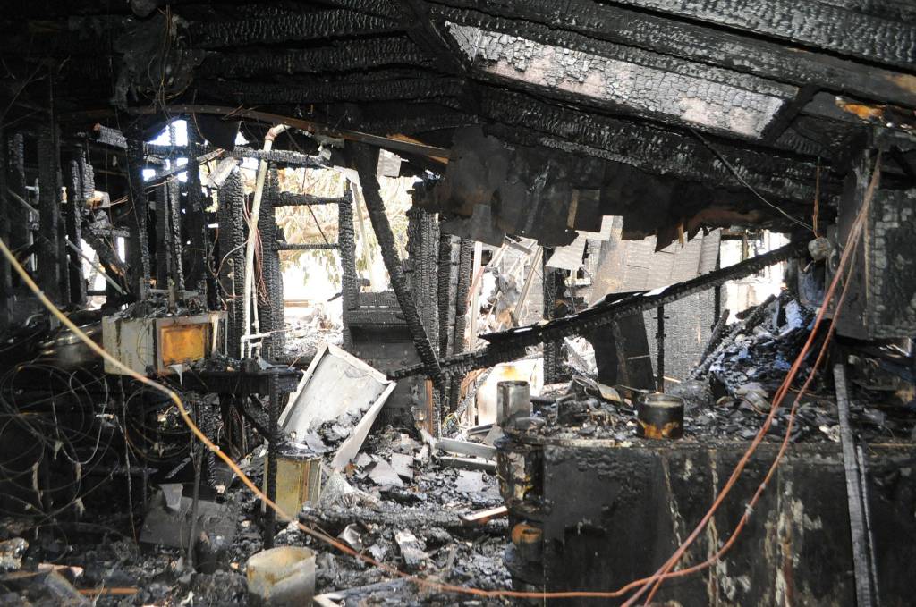 At one point, 25 firefighters were on scene from multiple agencies working to battle a fire on Spruce Street and prevent it from spreading to nearby residences. Sequim Gazette photo by Matthew Nash