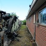 Sequim Police officers evacuated a nearby apartment building by the house fire for safety. The fire burned adjacent windows, but no other damage was reported to the apartments, fire officials report. Sequim Gazette photo by Matthew Nash