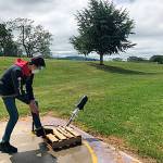 Sequim Middle School student Sam Cobb prepares to launch his pressurized 2-liter bottle rocket. Sams rocket traveled 98 meters. Photo by Joe Landoni