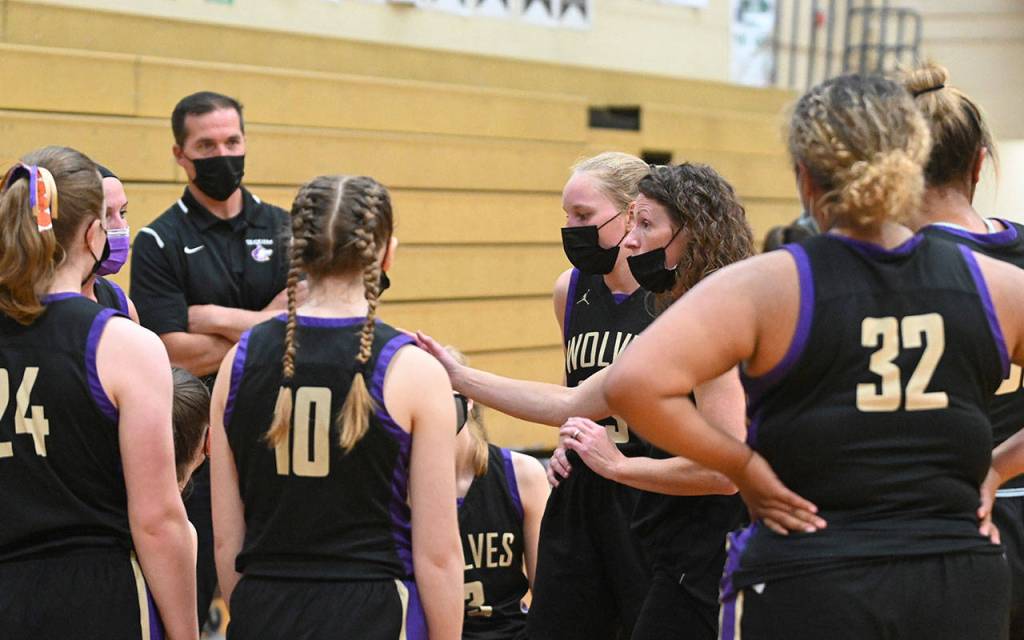 Sequim coach Linsay Rapelje, second from right, talks with her team in the second half of the Olympic League title game on June 9 in Port Angeles. Sequim Gazette photo by Michael Dashiell
