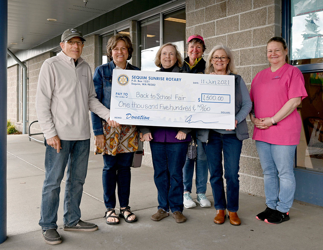The Back to School Fair committee accepts $1,500 from the Sequim Sunrise Rotary for the groups annual event set for Aug. 28. Pictured, from left, are: Rich Bemm, Sunrise Rotarian Community Service Director; Patsene Dashiell, Back To School committee member; Nan Burris, fair co-chair and Sequim Community Helping Kids member; Ann Flack, Sunrise Rotarian President Elect (in back); Becki Roberts, Sunrise Rotarian Community Service Director Elect, and Tessa Jackson, Sequim Boys & Girls Club unit director. Sequim Gazette staff photo