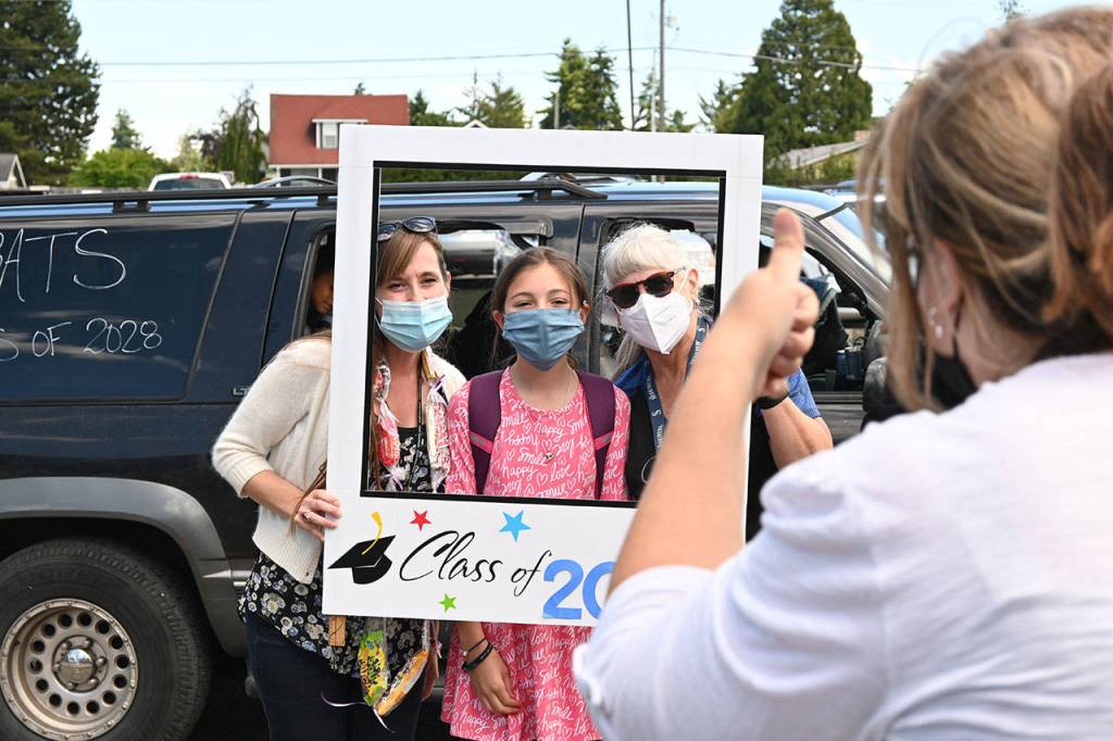 Fifth grade teachers Nathalie Maynock, left, and Teresa Iversen celebrate Greywolf Elementary fifth-grader Shaylee Furbee on the schools final in-person day on June 16. Sequim Gazette photo by Michael Dashiell