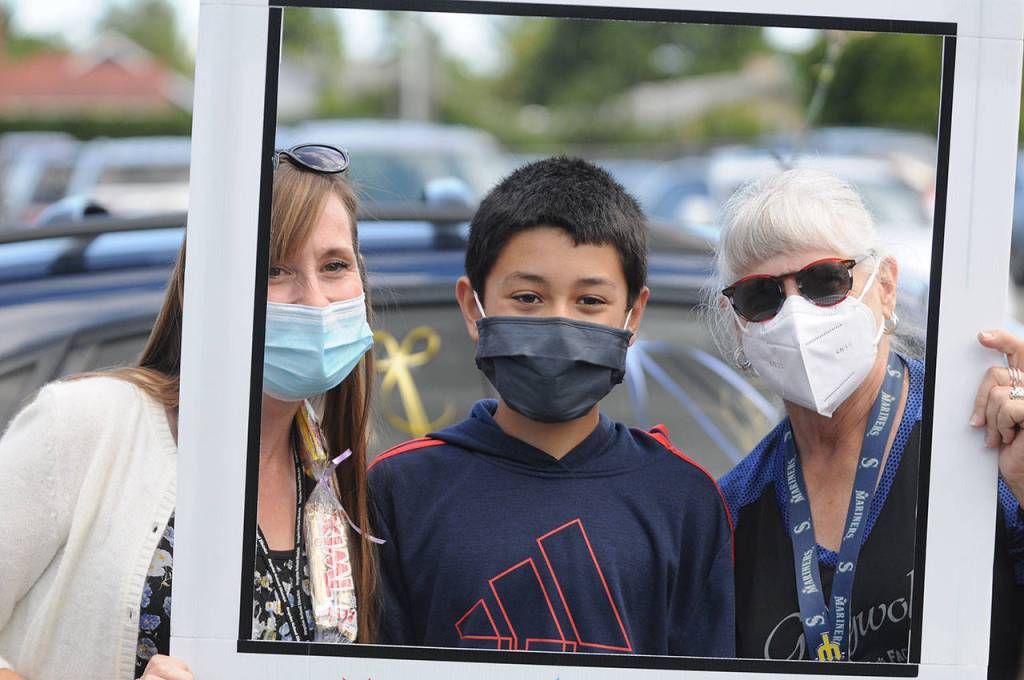 Fifth grade teachers Nathalie Maynock, left, and Teresa Iversen celebrate Greywolf Elementary fifth-grader Isaac Edgecomb on the schools final in-person day on June 16. Sequim Gazette photo by Michael Dashiell