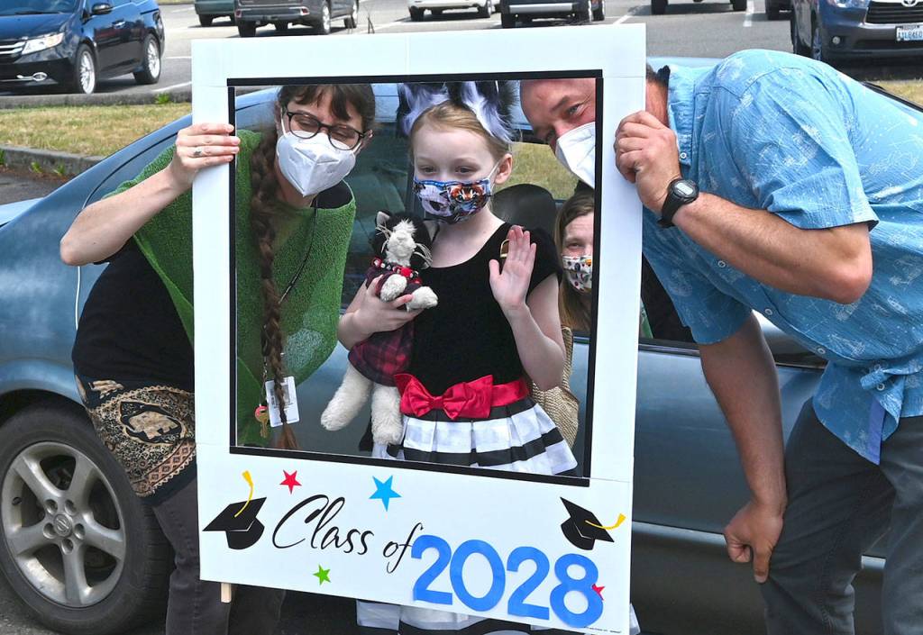 Fifth grade teacher Ashley Kramer and Aaron Reno celebrate Greywolf Elementary fifth-grader Maddy Parker on the schools final in-person day on June 16. Sequim Gazette photo by Michael Dashiell