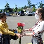 Helen Haller Elementary fifth-grader Mia Peralta Castro presents flowers to teacher Brittney Rothwell during a drive-through graduation ceremony on June 17. Sequim Gazette photos by Matthew Nash, Michael Dashiell