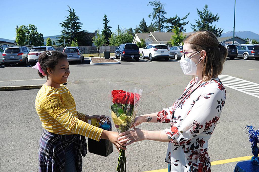Helen Haller Elementary fifth-grader Mia Peralta Castro presents flowers to teacher Brittney Rothwell during a drive-through graduation ceremony on June 17. Sequim Gazette photos by Matthew Nash, Michael Dashiell