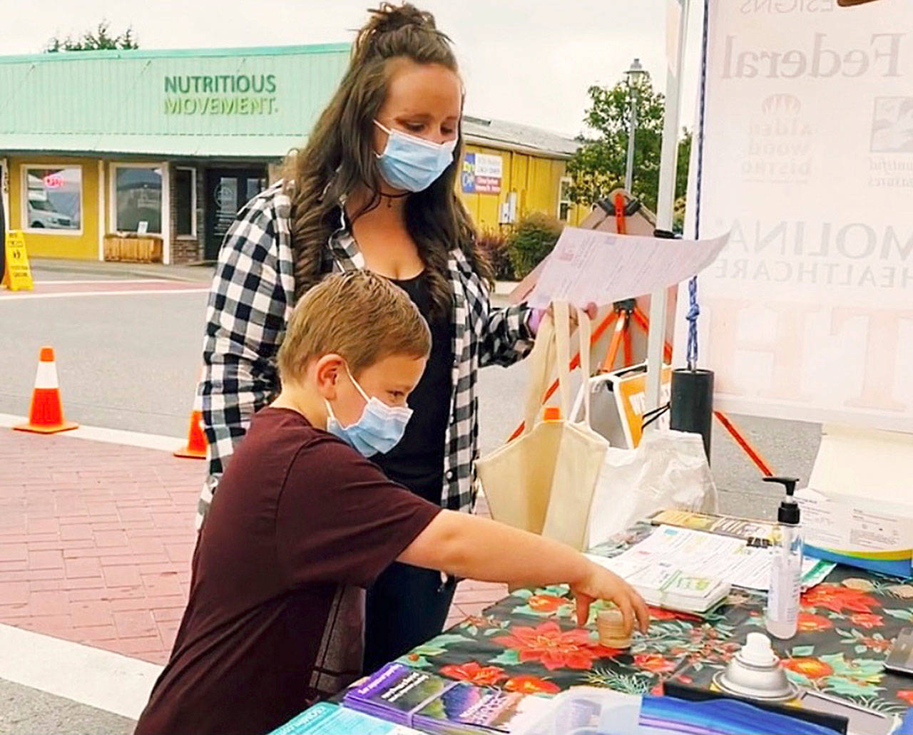Rebecca and Abel, Sequim Farmers & Artisans Markets SNAP ambassadors, redeem SNAP currency at the market. Photo by Emma Jane EJ Garcia