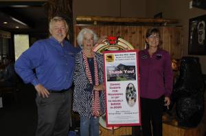 Over four years, Black Bear Diner customers have donated to the Captain Joseph House Foundation to support families of fallen soldiers. Last week, foundation executive director Betsy Reed Schultz shared a sign thanking the restaurant with owner Bret Wirta and manager Linda Donaghay accepting the sign. Sequim Gazette photo by Matthew Nash